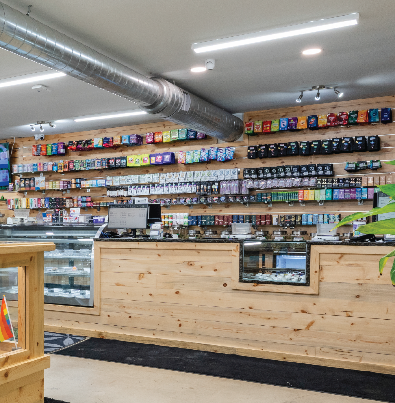 Interior view of the Life Flower Dispensary Glendale location with a sleek wood checkout counter, showcasing a premium selection of cannabis products.